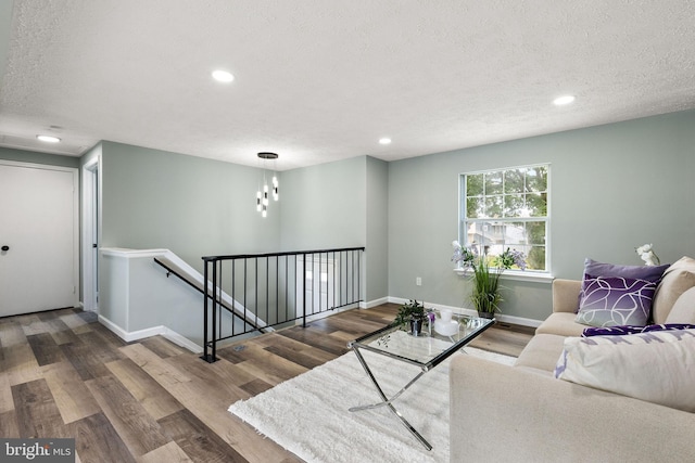 1207 Blithe Ct, Upper Marlboro, MD 20774 - living room featuring wood finished floors, a textured ceiling, baseboards, and recessed lighting