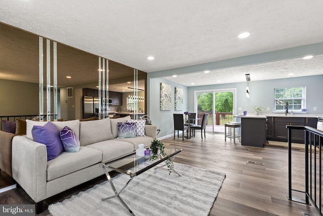 1207 Blithe Ct, Upper Marlboro, MD 20774 - living room with recessed lighting, light wood-style flooring, baseboards, and a textured ceiling