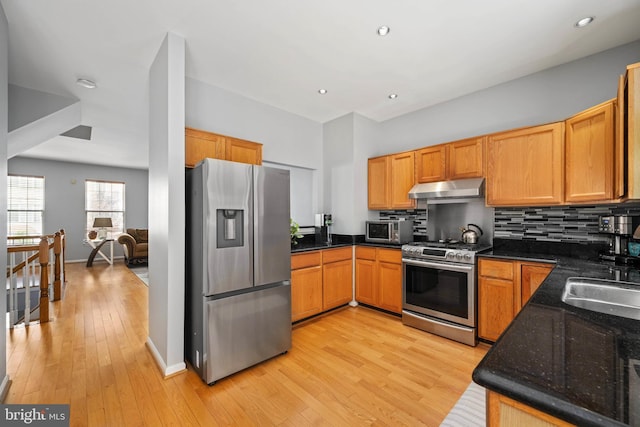 6164 Kendra Way, Centreville, VA 20121 - kitchen with stainless steel appliances, under cabinet range hood, light wood finished floors, backsplash, and dark stone counters