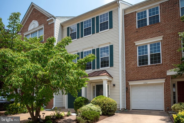 6164 Kendra Way, Centreville, VA 20121 - multi unit property with an attached garage, concrete driveway, a standing seam roof, metal roof, and brick siding