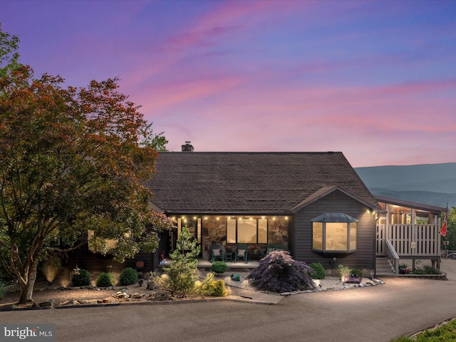 417 Mallard Dr, Basye, VA 22810 - rustic home featuring a chimney, covered porch, a shingled roof, and stone siding