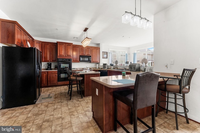 14207 Pollin St, Accokeek, MD 20607 - kitchen with black appliances, a peninsula, a breakfast bar area, a center island, and pendant lighting