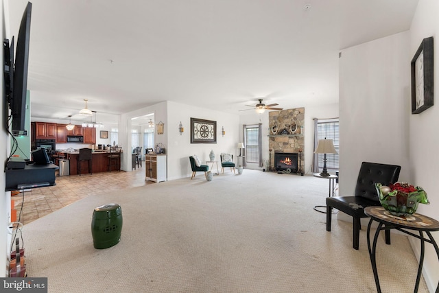 14207 Pollin St, Accokeek, MD 20607 - living area with a ceiling fan, light carpet, and a stone fireplace