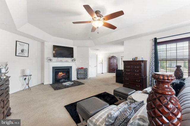 14207 Pollin St, Accokeek, MD 20607 - living room featuring carpet floors, ceiling fan, a fireplace with flush hearth, and a raised ceiling
