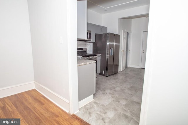 1626 N 30th St, Philadelphia, PA 19121 - kitchen featuring stainless steel appliances, light countertops, gray cabinets, tasteful backsplash, and baseboards