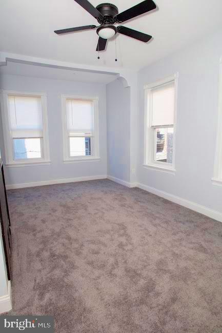 1626 N 30th St, Philadelphia, PA 19121 - unfurnished room featuring carpet floors, ceiling fan, baseboards, and arched walkways