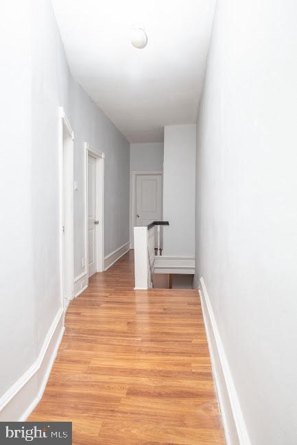 1626 N 30th St, Philadelphia, PA 19121 - hallway with light wood finished floors, baseboards, and an upstairs landing