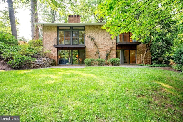 6501 Menlo Rd, Mclean, VA 22101 - rear view of house featuring a lawn, a chimney, and brick siding
