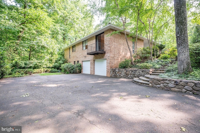 6501 Menlo Rd, Mclean, VA 22101 - view of property exterior with driveway, a balcony, a garage, and brick siding