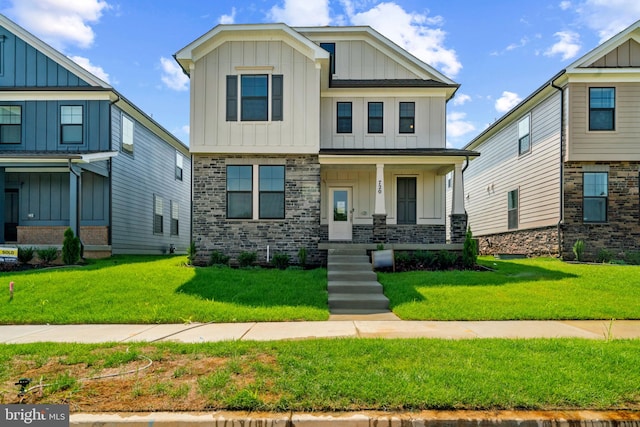 465 Hanson St, Frederick, MD 21701 - view of front facade with board and batten siding, covered porch, and a front lawn