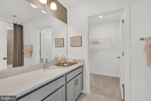 465 Hanson St, Frederick, MD 21701 - bathroom with vanity, a walk in closet, tile patterned floors, and shower / bath combo with shower curtain