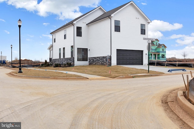 465 Hanson St, Frederick, MD 21701 - view of front of home featuring an attached garage, driveway, and stone siding