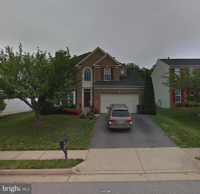 13137 Kinnicutt Dr, Woodbridge, VA 22192 - traditional-style house featuring asphalt driveway, brick siding, a front lawn, and a garage
