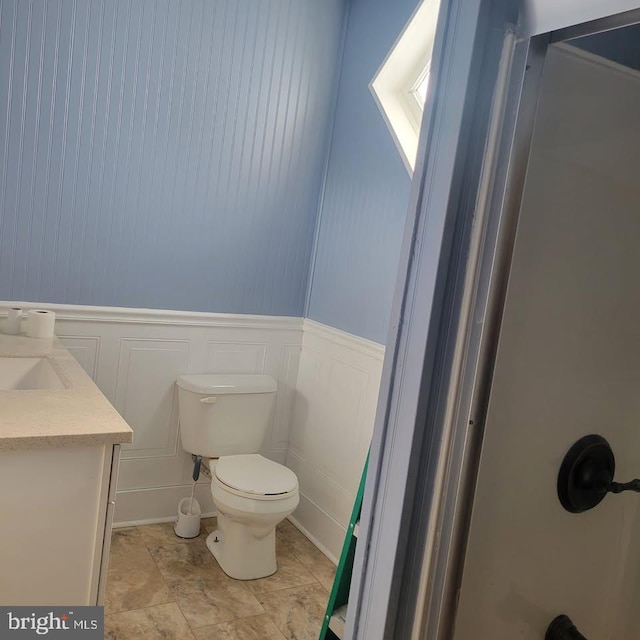 89 S Mineral St, Keyser, WV 26726 - bathroom featuring toilet, a decorative wall, vanity, and wainscoting