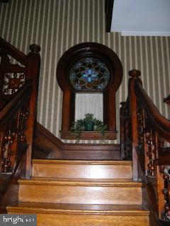 89 S Mineral St, Keyser, WV 26726 - stairs featuring wallpapered walls and wood finished floors