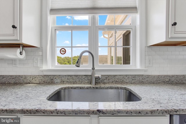 3 Rycroft Rd, Mechanicsburg, PA 17050 - kitchen view of a sink, white cabinets, backsplash, and light stone counters