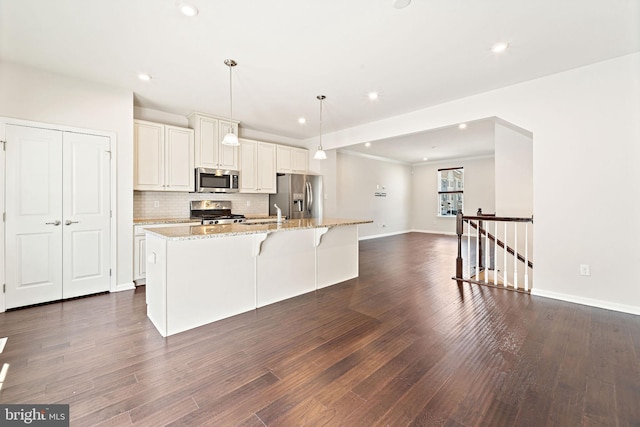 1307 Kohana Dr, Clarksboro, NJ 08020 - kitchen with stainless steel appliances, an island with sink, tasteful backsplash, baseboards, and light stone counters