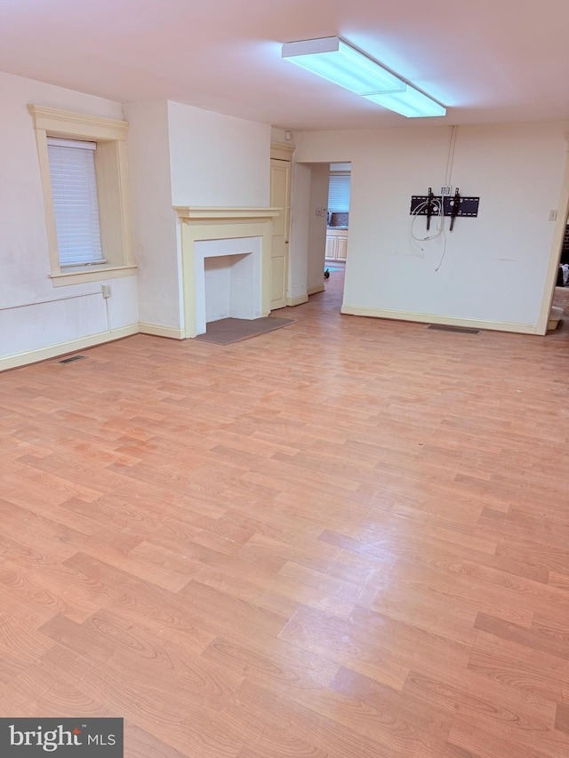 2410 Chichester Ave, Upper Chichester, PA 19061 - unfurnished living room with light wood-style flooring, baseboards, and a fireplace