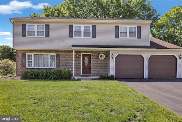 2110 Buckman Ave, Reading, PA 19610 - view of front of property featuring asphalt driveway, a front lawn, and brick siding