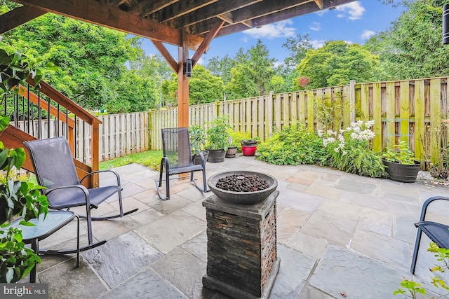 603 Howitzer Ter NE, Leesburg, VA 20176 - fenced backyard featuring a patio area and view of scattered trees