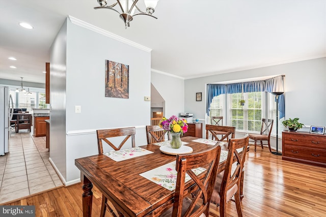 603 Howitzer Ter NE, Leesburg, VA 20176 - dining space featuring a chandelier, light wood-style floors, ornamental molding, and recessed lighting