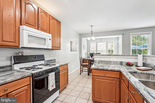 603 Howitzer Ter NE, Leesburg, VA 20176 - kitchen featuring white appliances, a chandelier, and brown cabinets