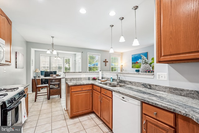 603 Howitzer Ter NE, Leesburg, VA 20176 - kitchen featuring dishwasher, gas range oven, light stone counters, brown cabinetry, and light tile patterned floors