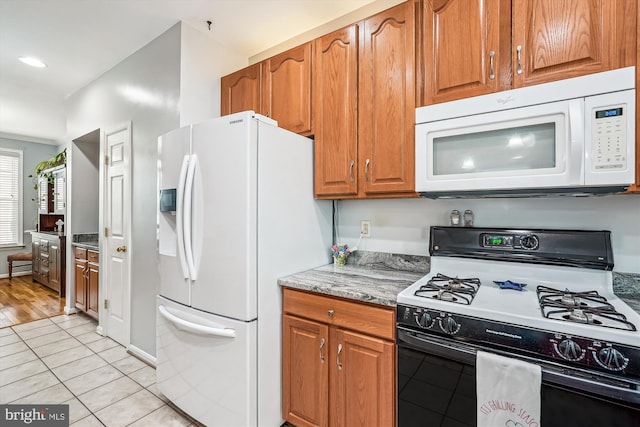 603 Howitzer Ter NE, Leesburg, VA 20176 - kitchen featuring white appliances, light tile patterned flooring, brown cabinets, light stone countertops, and recessed lighting