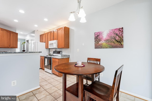 603 Howitzer Ter NE, Leesburg, VA 20176 - kitchen featuring range with gas cooktop, white microwave, a chandelier, light tile patterned flooring, and recessed lighting