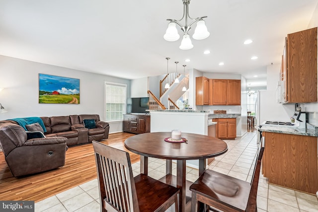 603 Howitzer Ter NE, Leesburg, VA 20176 - dining area with a chandelier, stairway, light tile patterned flooring, and recessed lighting