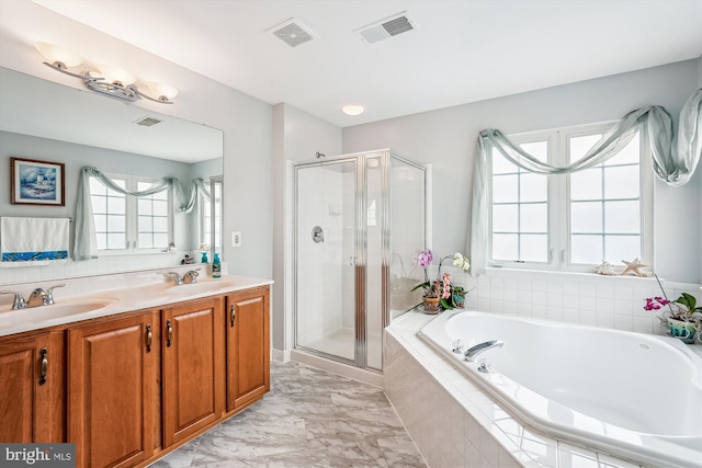 603 Howitzer Ter NE, Leesburg, VA 20176 - full bath featuring a garden tub, a shower stall, plenty of natural light, and double vanity