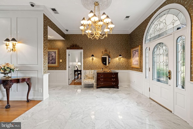 77 Lionheart Ter, Falling Waters, WV 25419 - foyer with a decorative wall, crown molding, a chandelier, and a wainscoted wall