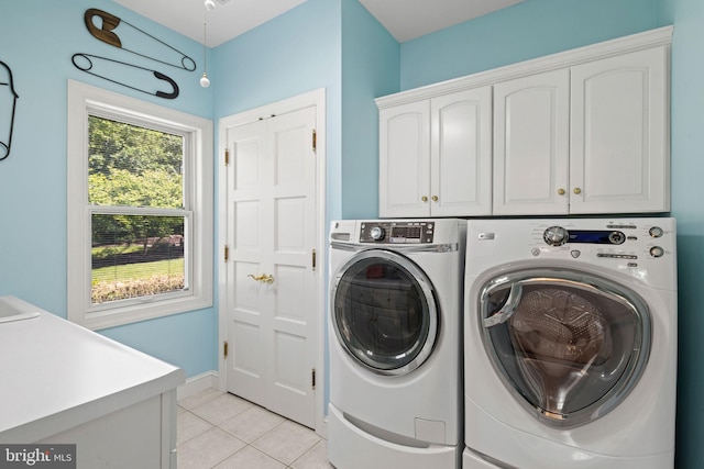 77 Lionheart Ter, Falling Waters, WV 25419 - laundry area with cabinet space, light tile patterned flooring, and separate washer and dryer