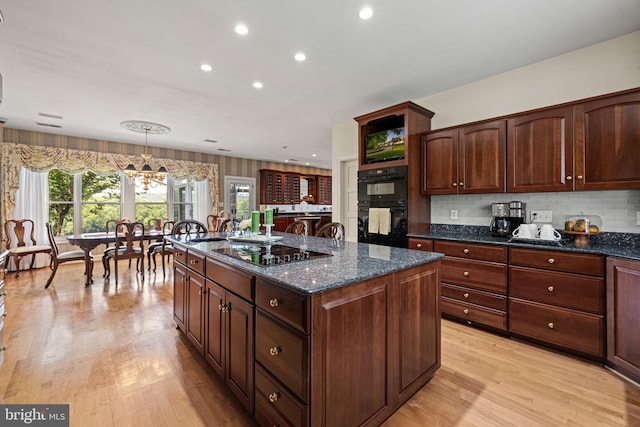 77 Lionheart Ter, Falling Waters, WV 25419 - kitchen with a chandelier, light wood-type flooring, black appliances, dark stone counters, and recessed lighting