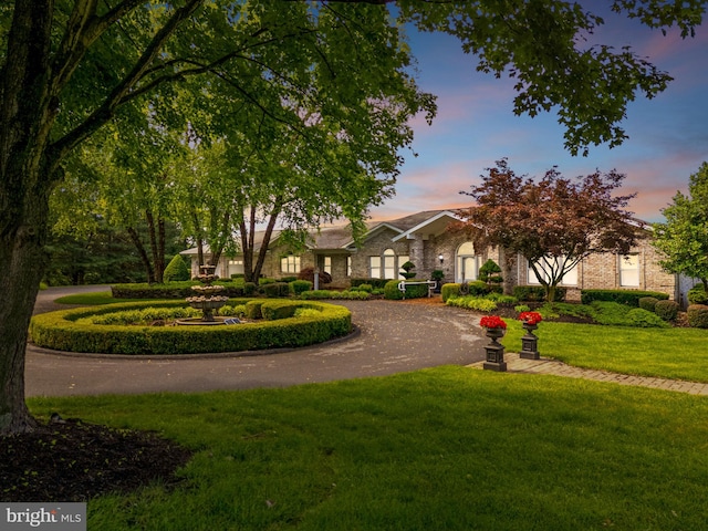 77 Lionheart Ter, Falling Waters, WV 25419 - view of front of property featuring a front yard, curved driveway, and brick siding