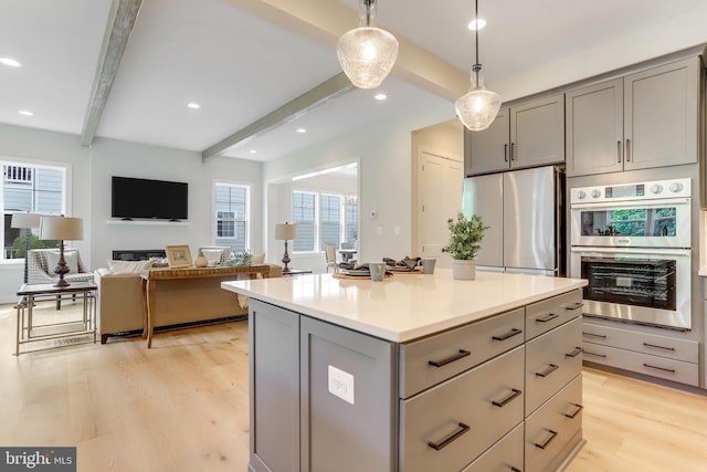 5809 2nd St S, Arlington, VA 22204 - kitchen featuring gray cabinetry, stainless steel appliances, beam ceiling, light wood-style flooring, and decorative light fixtures