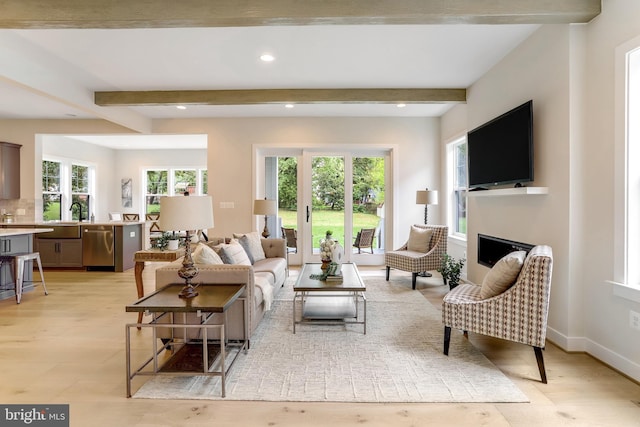 5809 2nd St S, Arlington, VA 22204 - living area featuring beamed ceiling, recessed lighting, light wood-style floors, a fireplace, and baseboards