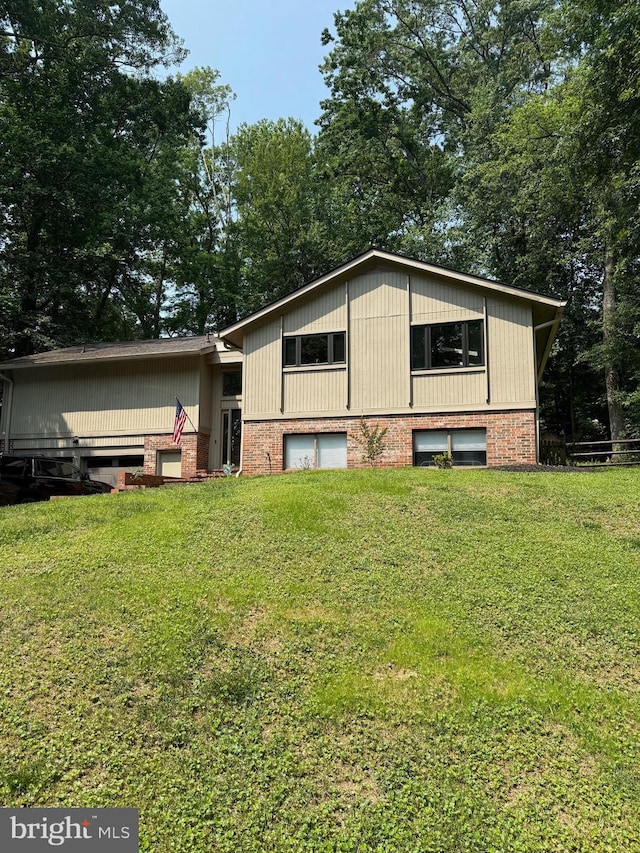 2404 Sugarberry Ct, Reston, VA 20191 - view of home's exterior featuring a yard, an attached garage, and brick siding