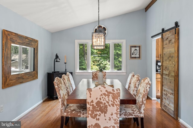 2404 Sugarberry Ct, Reston, VA 20191 - dining space with vaulted ceiling, wood finished floors, a barn door, baseboards, and a chandelier