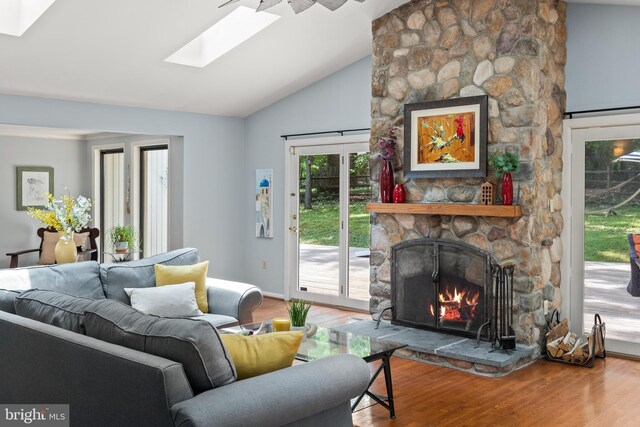 2404 Sugarberry Ct, Reston, VA 20191 - living room with a skylight, wood finished floors, a fireplace, and high vaulted ceiling
