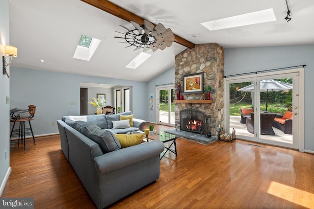 2404 Sugarberry Ct, Reston, VA 20191 - living area with a skylight, wood finished floors, a fireplace, and baseboards