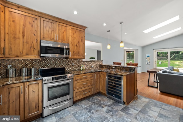 2404 Sugarberry Ct, Reston, VA 20191 - kitchen featuring stainless steel appliances, beverage cooler, brown cabinetry, lofted ceiling, and recessed lighting