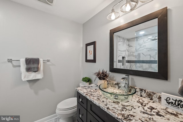 2404 Sugarberry Ct, Reston, VA 20191 - full bath featuring vanity, a marble finish shower, toilet, and baseboards