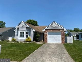 114 Mohican Ln, Tuckerton, NJ 08087 - ranch-style home featuring concrete driveway, a front lawn, an attached garage, and brick siding