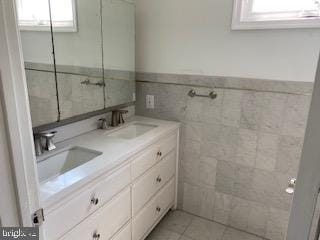 114 Mohican Ln, Tuckerton, NJ 08087 - full bathroom with double vanity, tile walls, a wainscoted wall, and tile patterned floors