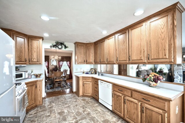574 Mathias Rd, Littlestown, PA 17340 - kitchen featuring white appliances, light countertops, brown cabinets, a chandelier, and recessed lighting