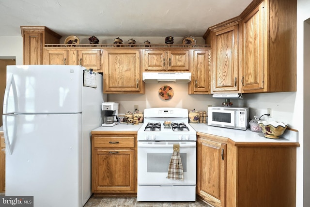 574 Mathias Rd, Littlestown, PA 17340 - kitchen with white appliances, under cabinet range hood, light countertops, and brown cabinets