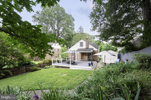 4741 20th St N, Arlington, VA 22207 - rear view of house with a storage shed, brick siding, a fenced backyard, and a wooden deck