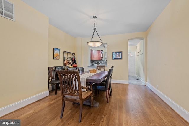 3004 E Pratt St, Baltimore, MD 21224 - dining room featuring arched walkways and wood finished floors