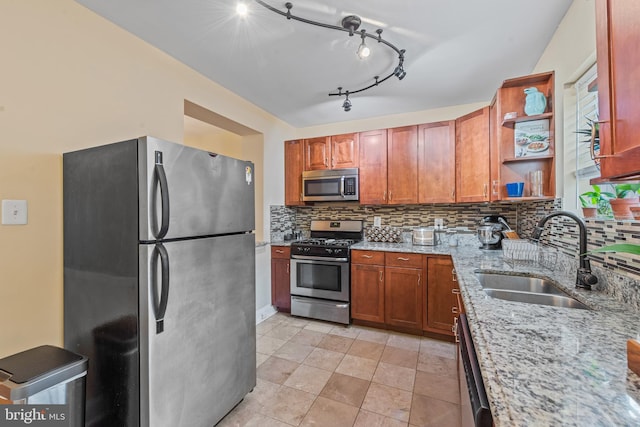 3004 E Pratt St, Baltimore, MD 21224 - kitchen featuring appliances with stainless steel finishes, open shelves, backsplash, light stone countertops, and brown cabinetry
